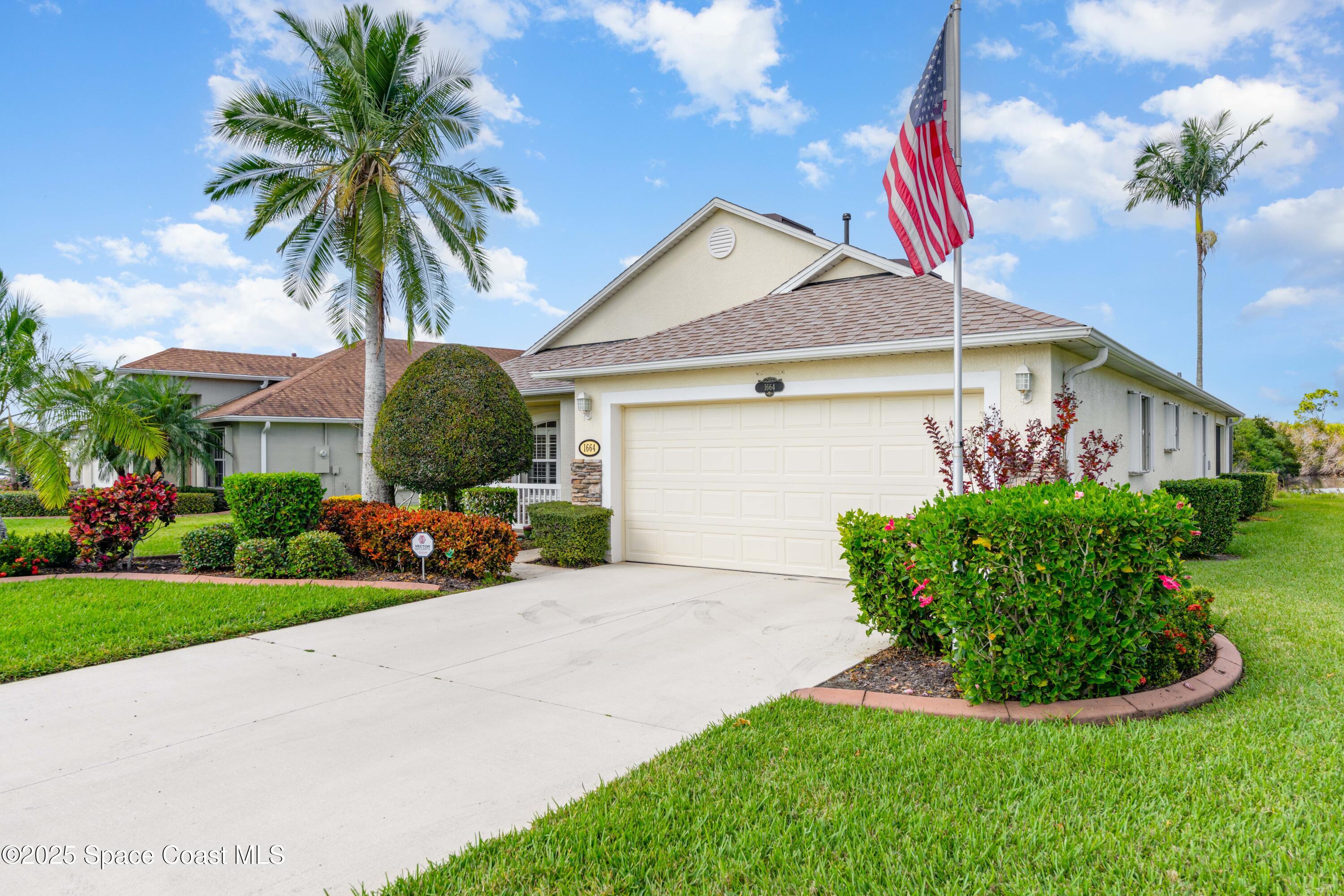 1664 Boca Rio Drive Melbourne, FL 32940 - Photo 3 of 46 a front view of a house with garden and plants