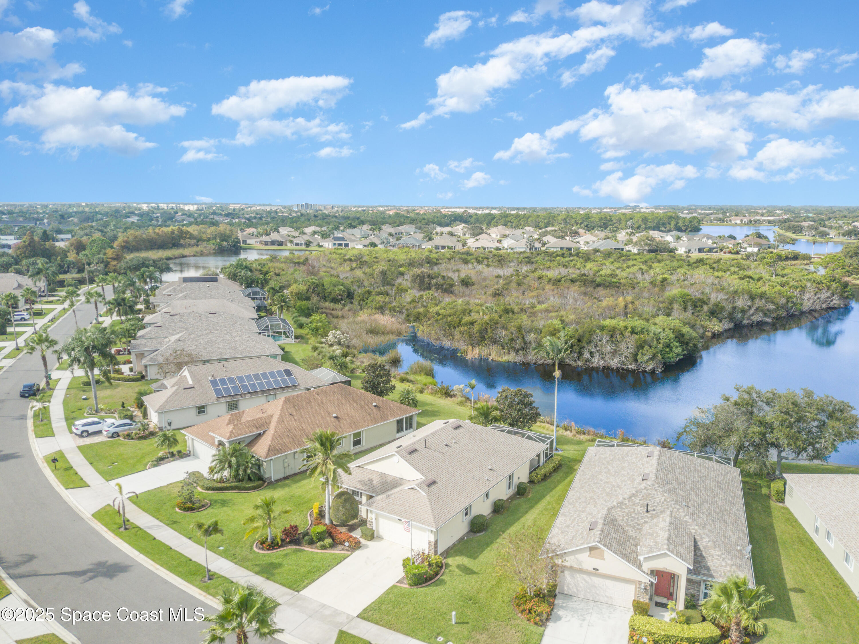 1664 Boca Rio Drive Melbourne, FL 32940 - Photo 31 of 46 an aerial view of residential houses with outdoor space and lake view