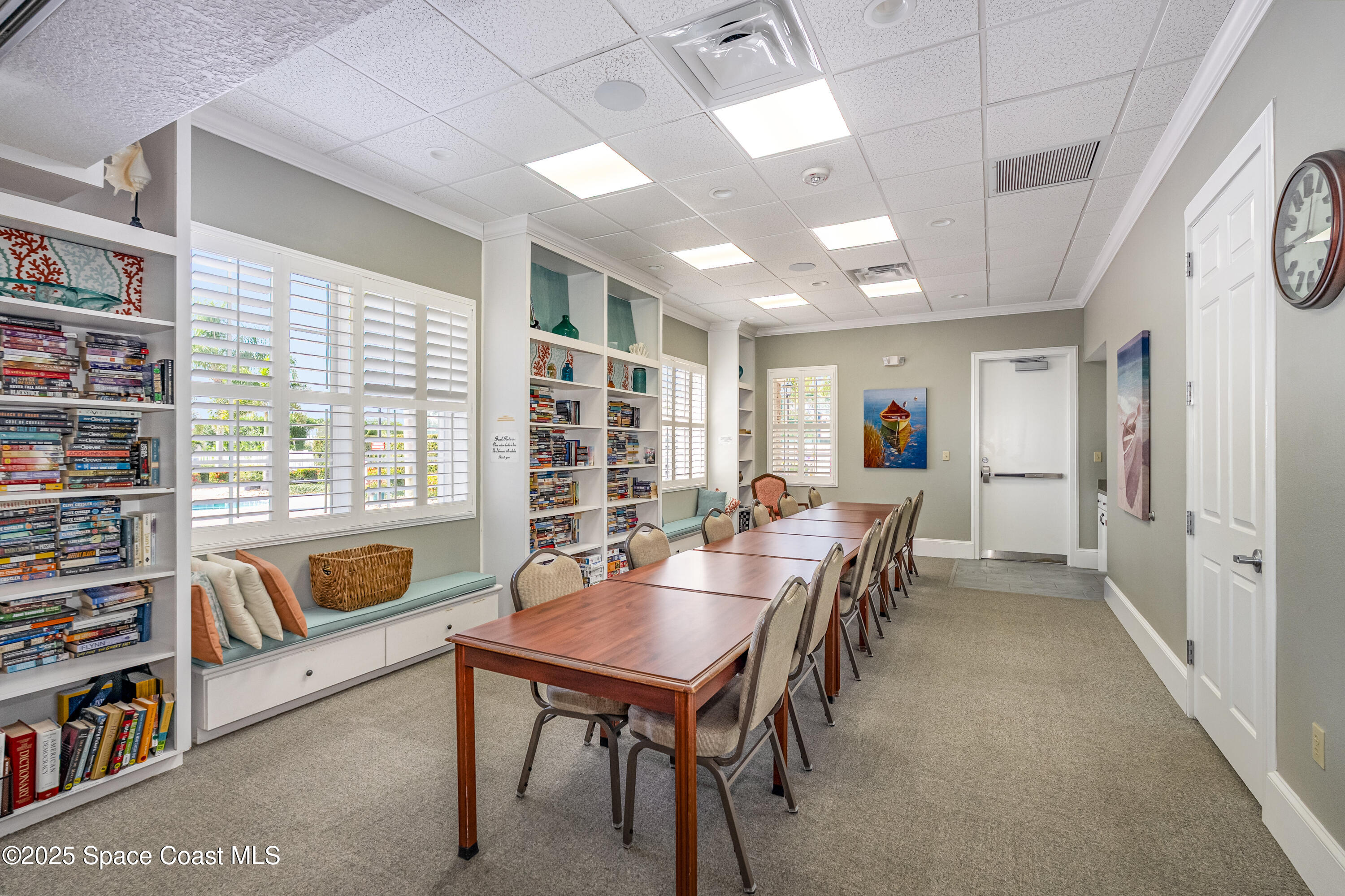 1664 Boca Rio Drive Melbourne, FL 32940 - Photo 42 of 46 a living room with furniture a rug and a book shelf
