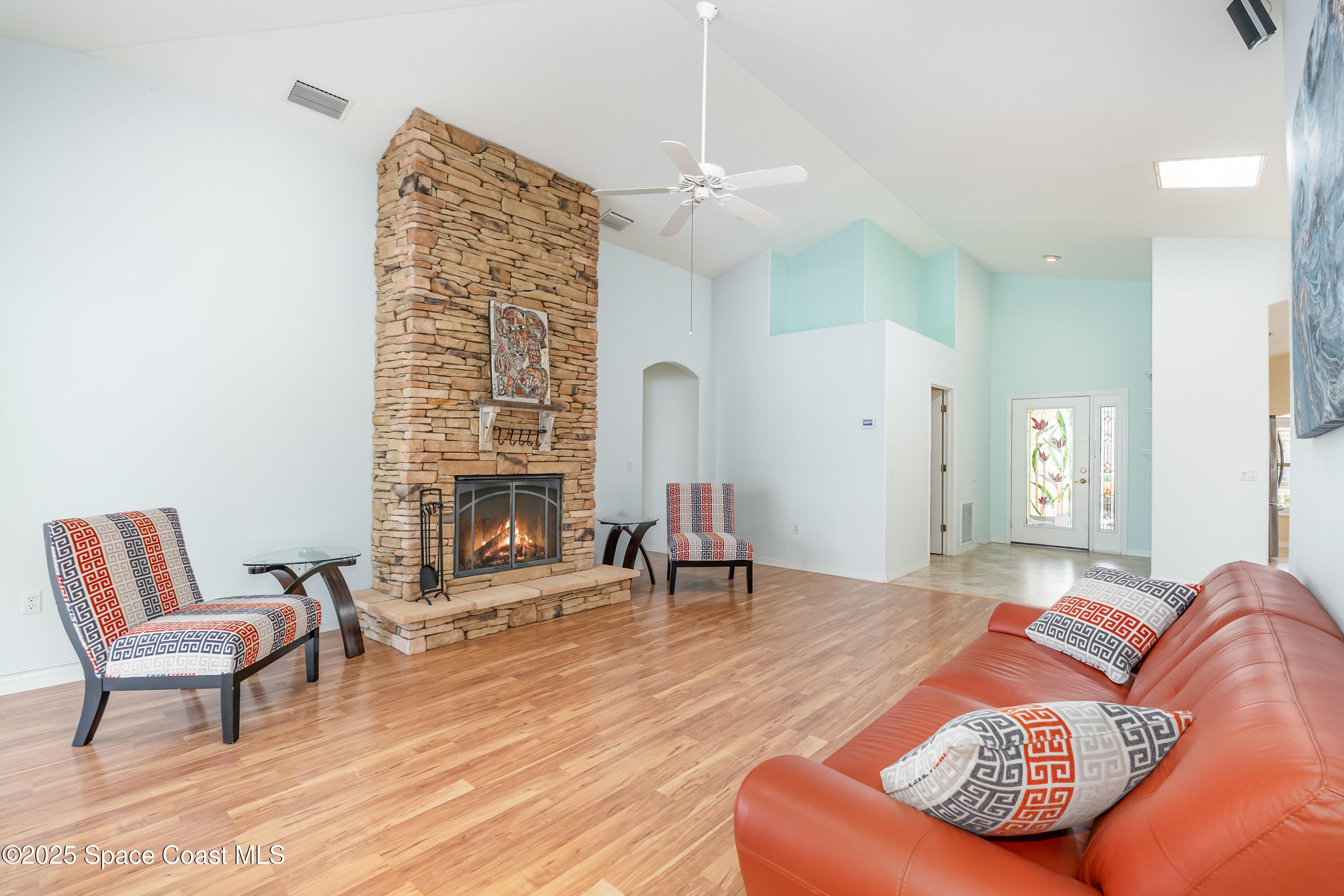 1664 Boca Rio Drive Melbourne, FL 32940 - Photo 9 of 46 a living room with furniture and a fireplace