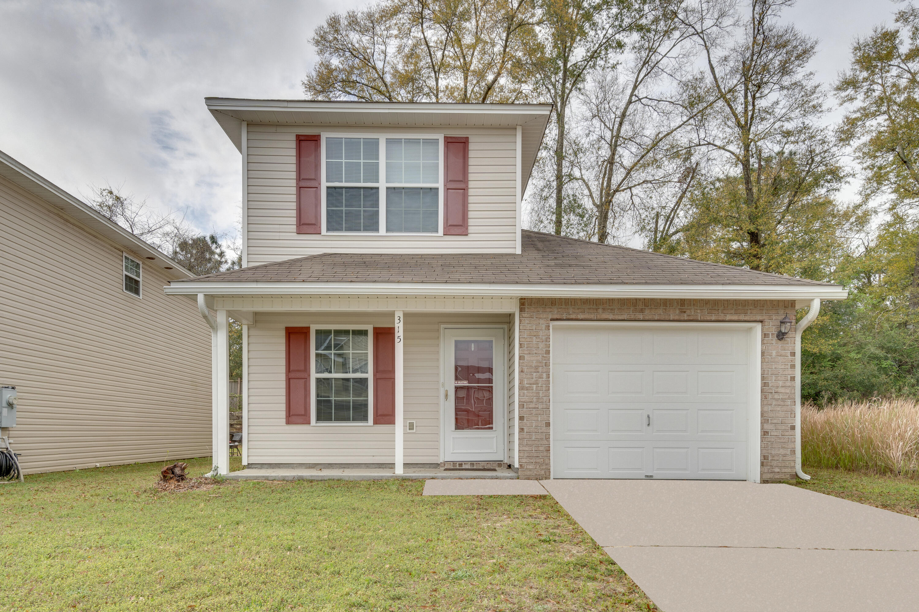 315 Dahlquist Drive Crestview, FL 32539 - Photo 1 of 32 a front view of a house with a garden