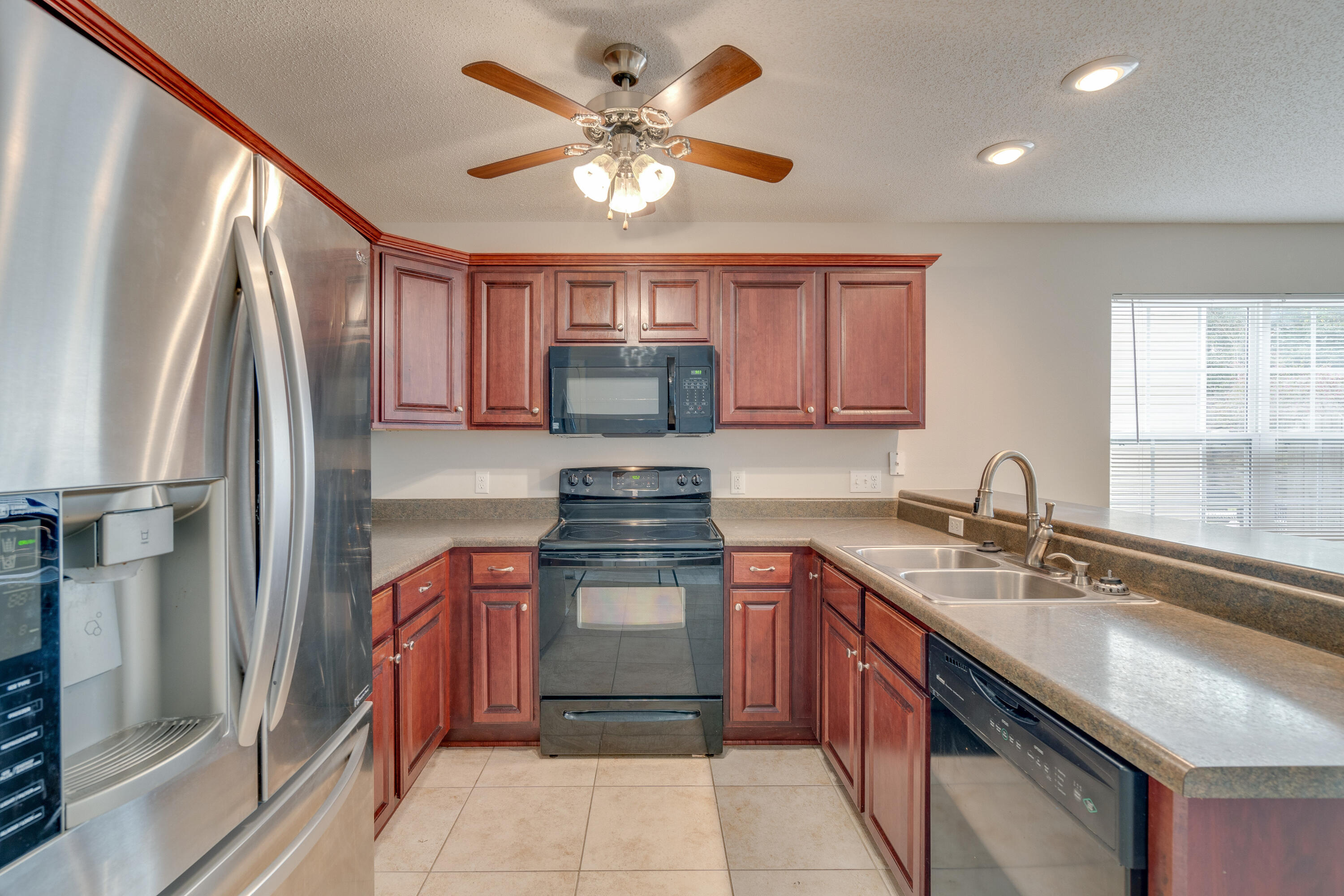 315 Dahlquist Drive Crestview, FL 32539 - Photo 13 of 32 a kitchen with stainless steel appliances granite countertop a sink stove and refrigerator