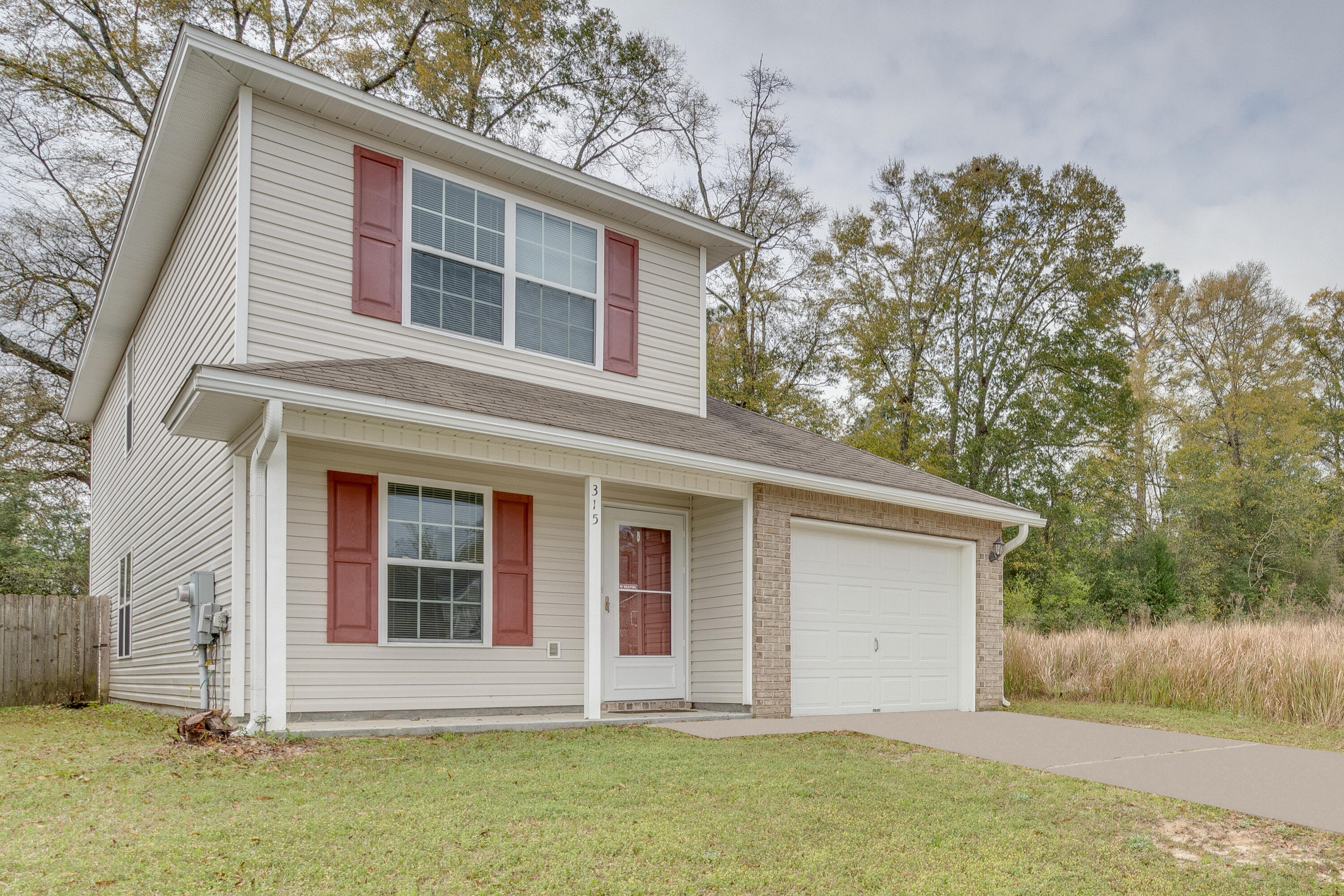 315 Dahlquist Drive Crestview, FL 32539 - Photo 2 of 32 a front view of a house with a garden