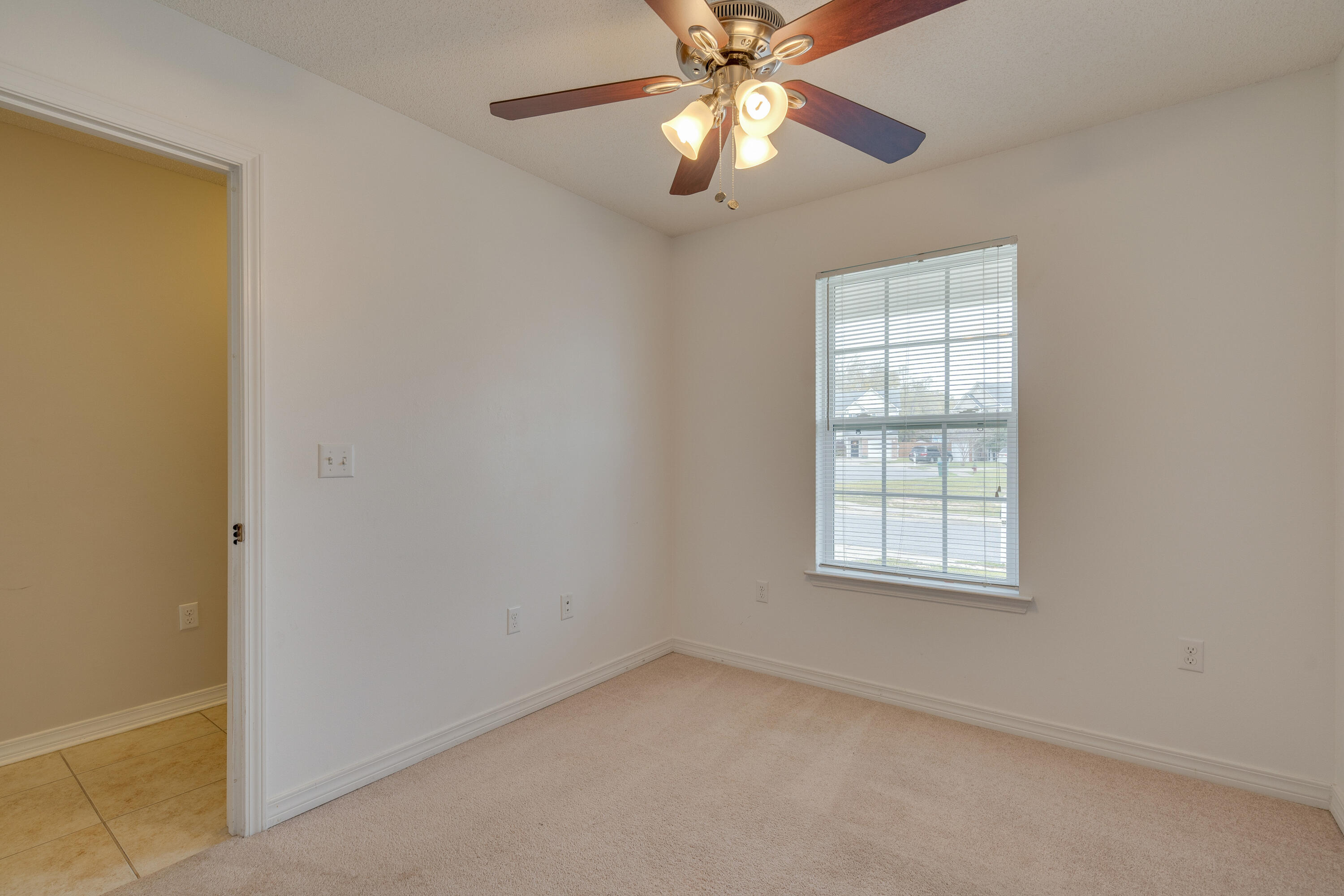 315 Dahlquist Drive Crestview, FL 32539 - Photo 22 of 32 an empty room with windows and fan