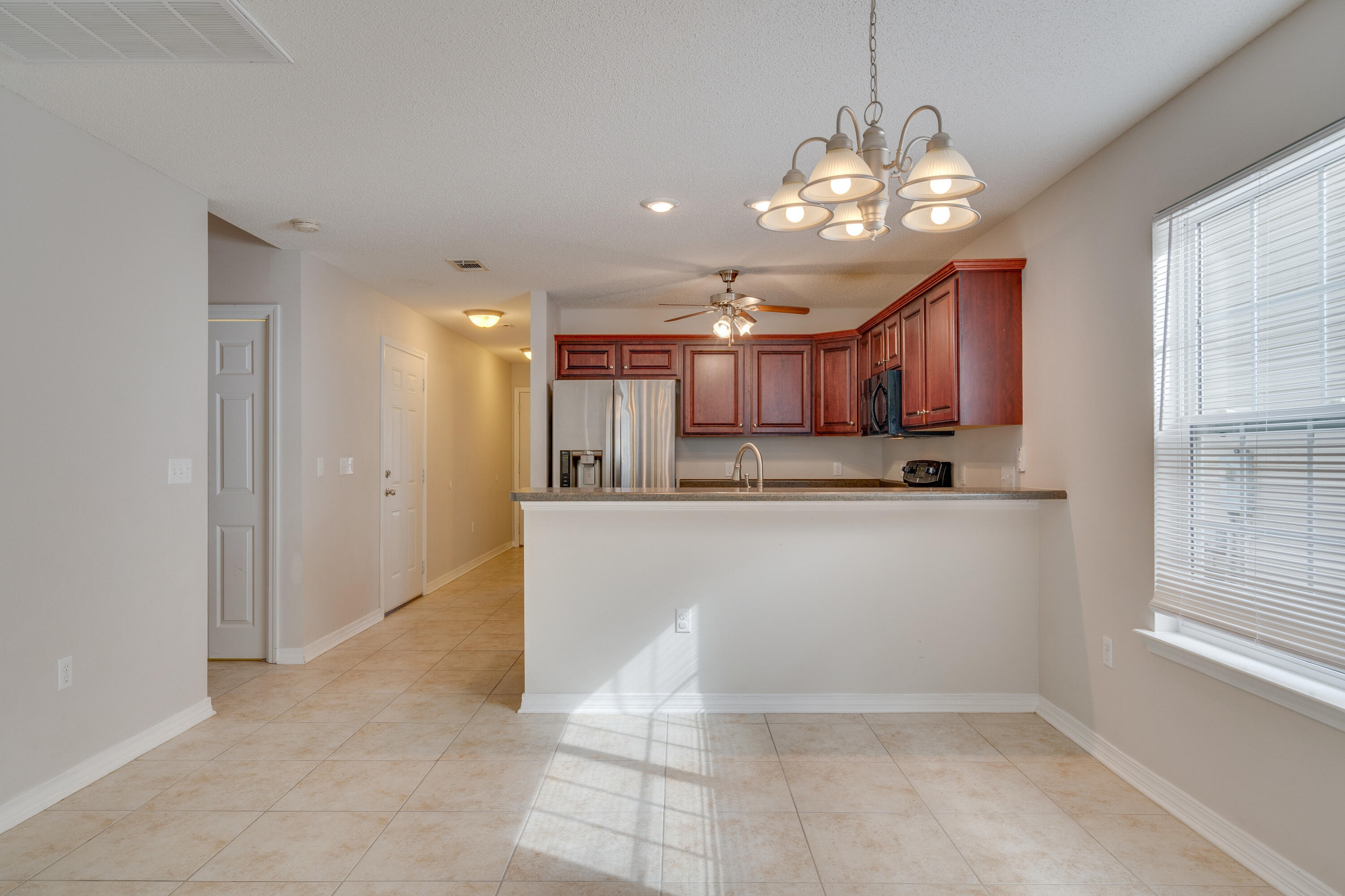 315 Dahlquist Drive Crestview, FL 32539 - Photo 9 of 32 a view of kitchen with refrigerator and window