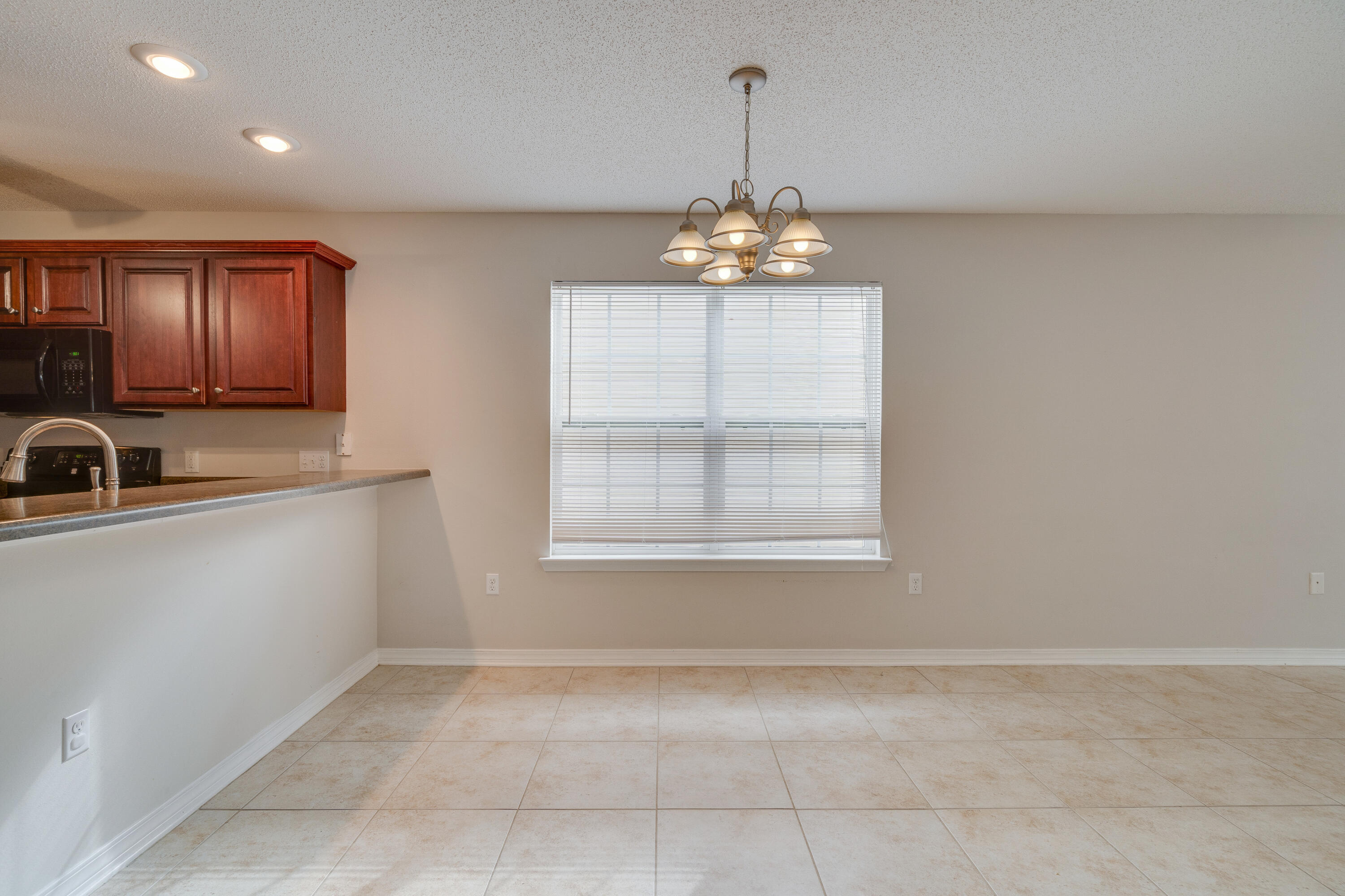 315 Dahlquist Drive Crestview, FL 32539 - Photo 10 of 32 a view of a kitchen with windows and chandelier