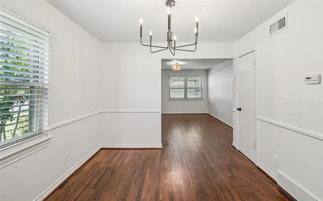 a view of wooden floor and windows in a room