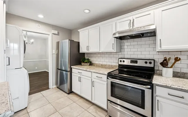 a kitchen with granite countertop cabinets and steel stainless steel appliances