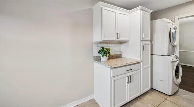 a utility room with cabinets washer and dryer