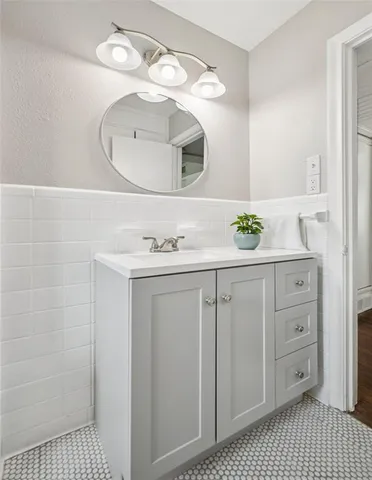 a bathroom with a sink a vanity and a mirror