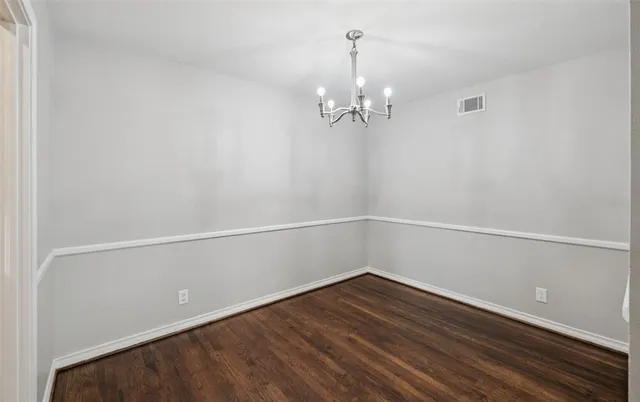 a view of a room with wooden floor and a window