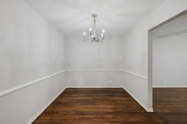 a view of a room with wooden floor and white walls