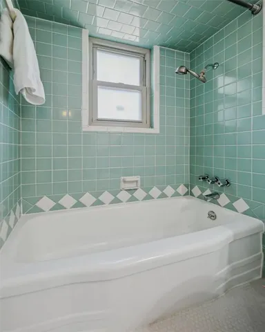 a bathroom with a bathtub and shower