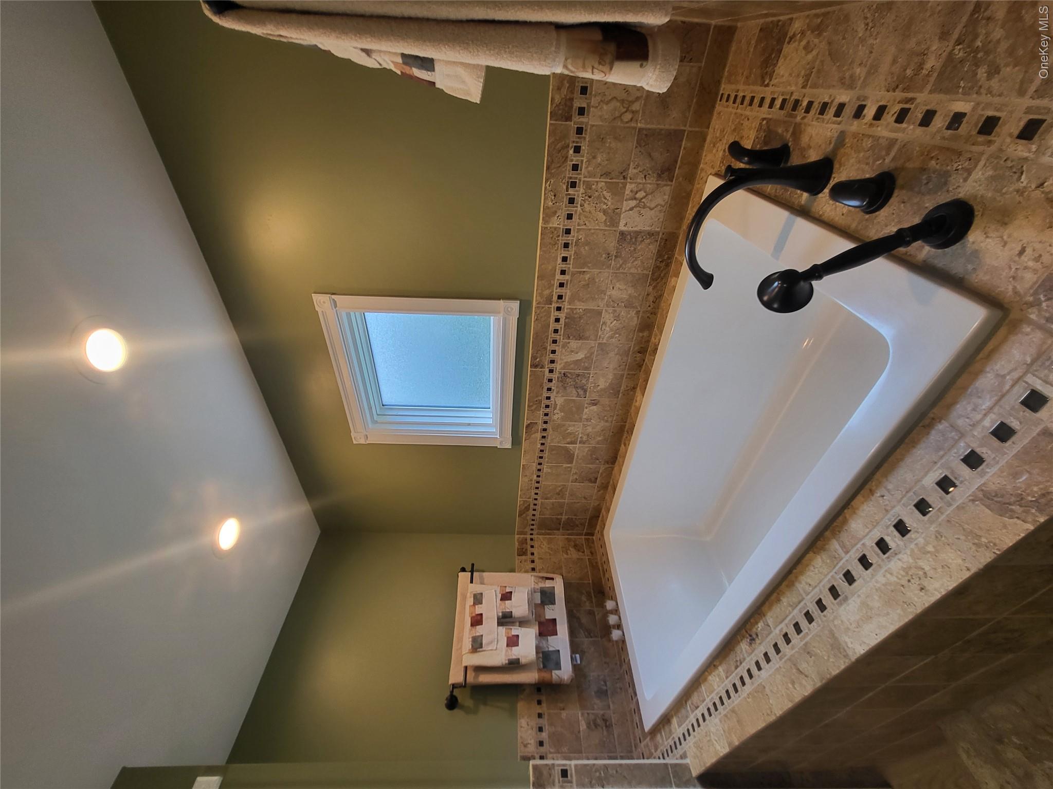 286 Dingle Daisy Road Monticello, NY 12701 - Photo 20 of 35 a bathroom with a tub sink and mirror