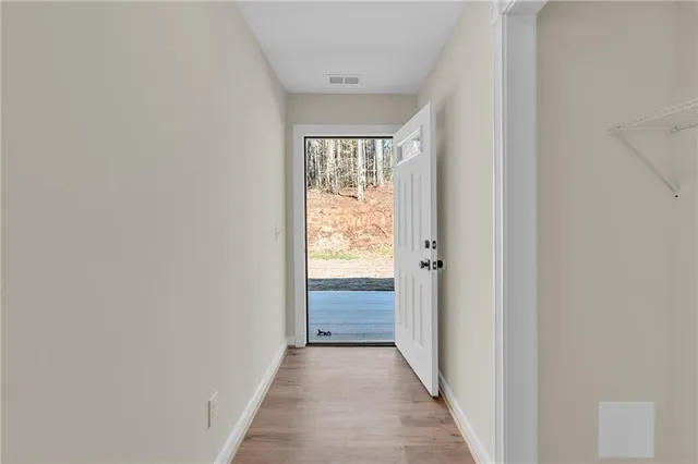 a backyard of a house with a yard and large trees