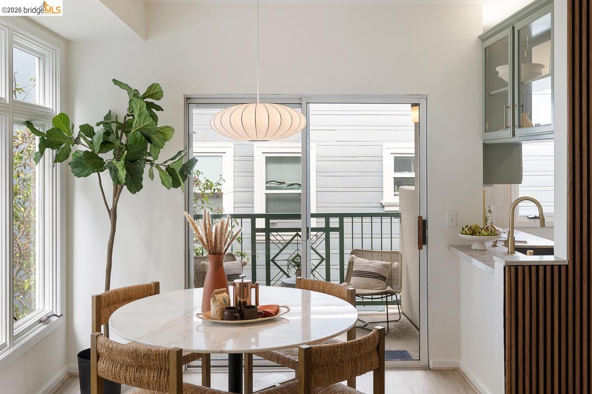 2029 Channing Way, Unit 3D Berkeley, CA 94704 - Photo 48 of 54 Dining area featuring a round stone-finish table and a contemporary pendant light