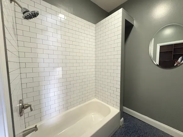 a bathroom with a bathtub and shower