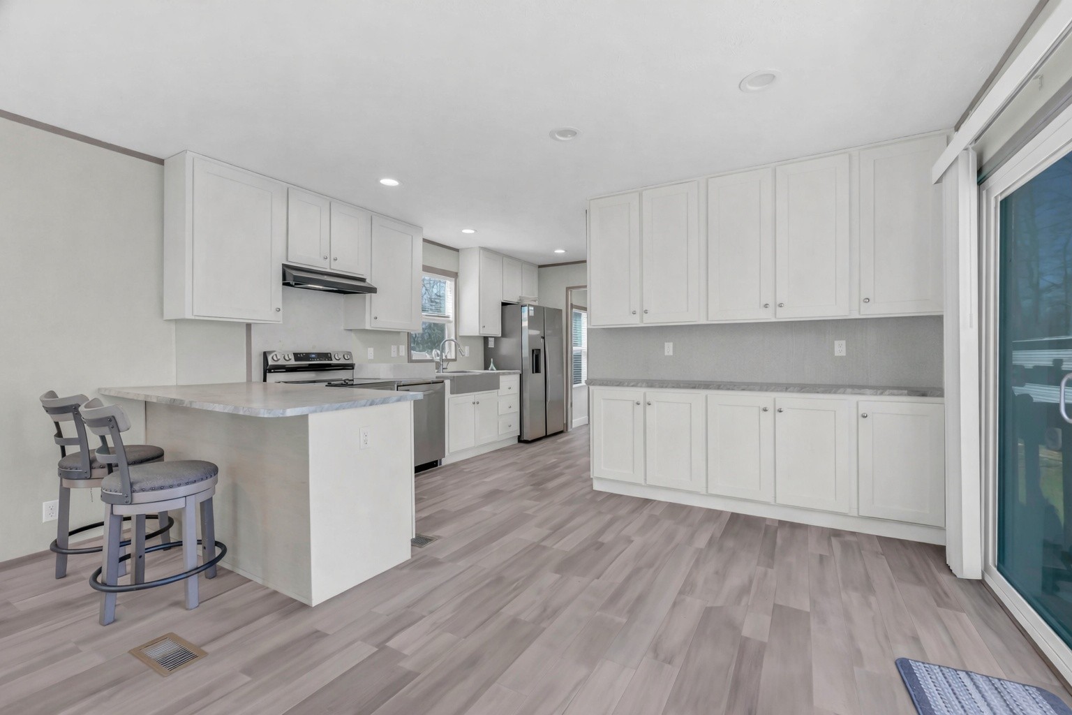 4819 Tarsus Road Palmyra, TN 37142 - Photo 12 of 15 a kitchen with wooden floors and white appliances