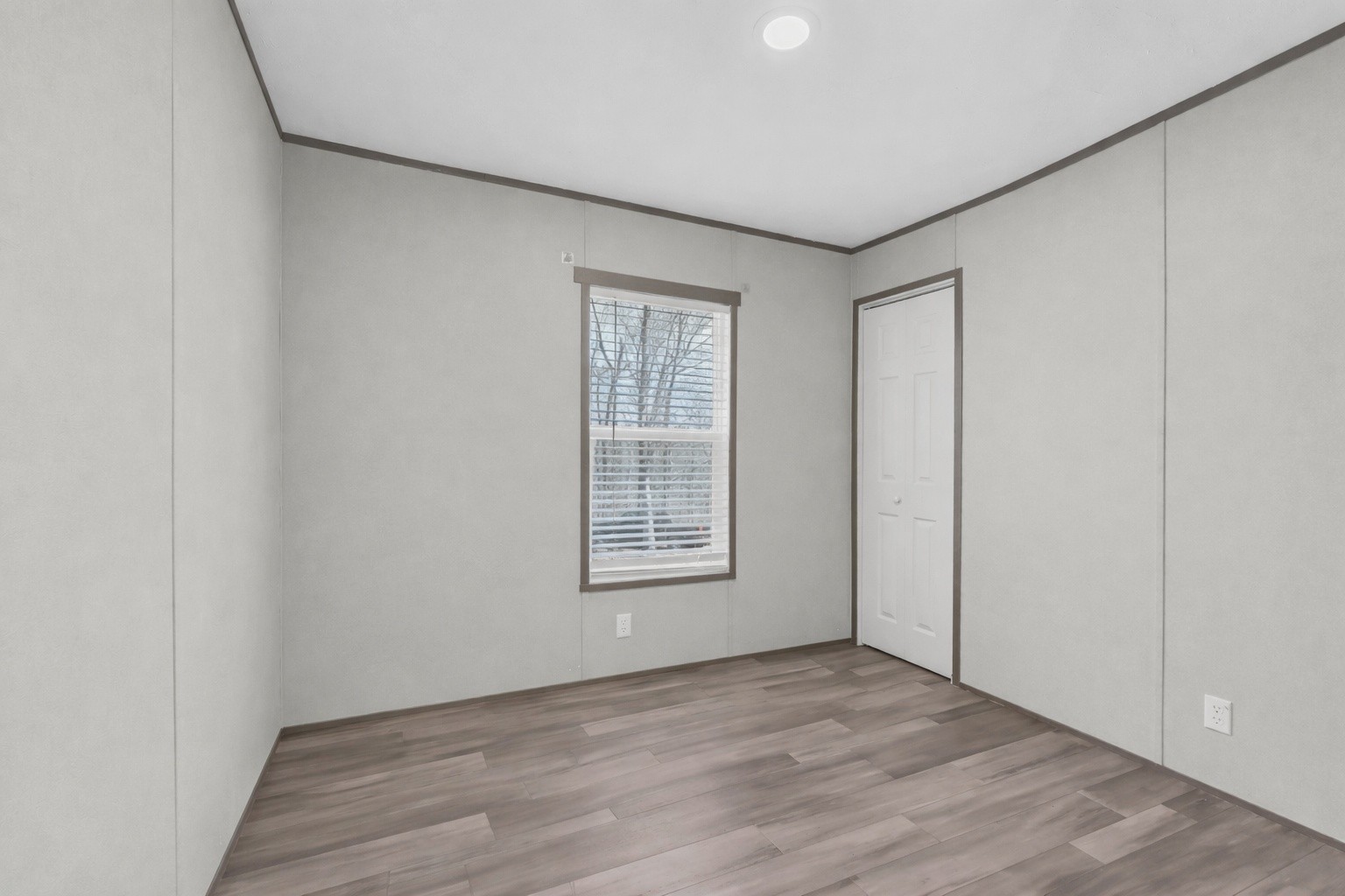 4819 Tarsus Road Palmyra, TN 37142 - Photo 4 of 15 a view of an empty room with wooden floor and a window