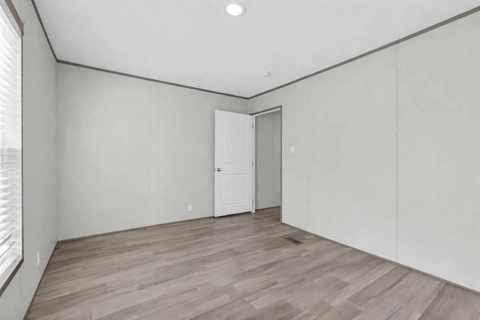 4819 Tarsus Road Palmyra, TN 37142 - Photo 6 of 15 a view of an empty room with wooden floor and a window