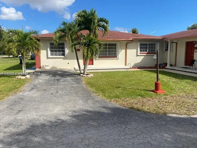 a house that has a tree in front of it