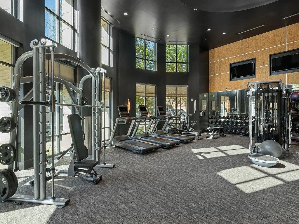 2724 Kipling Street, Unit 504 Houston, TX 77098 - Photo 15 of 30 The cardio suite is positioned directly in front of massive windows, ensuring you never feel boxed in while you work on your endurance.