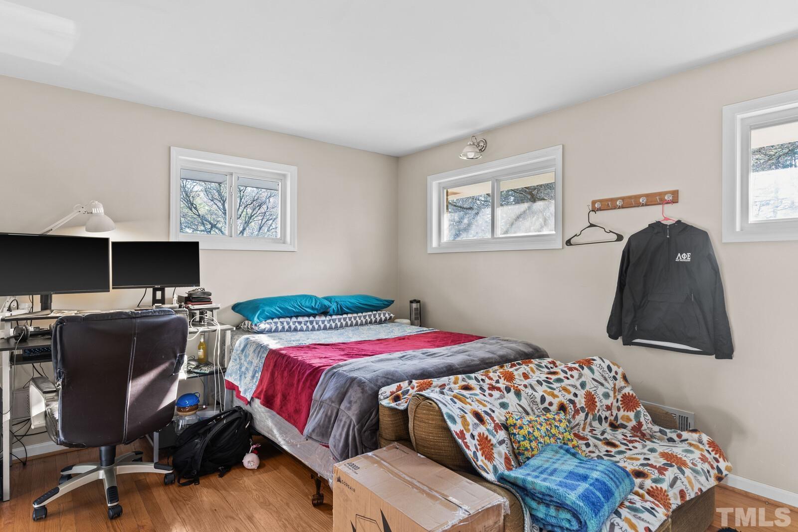 827 Athens Drive Raleigh, NC 27606 - Photo 13 of 34 a bedroom with a bed and a desk