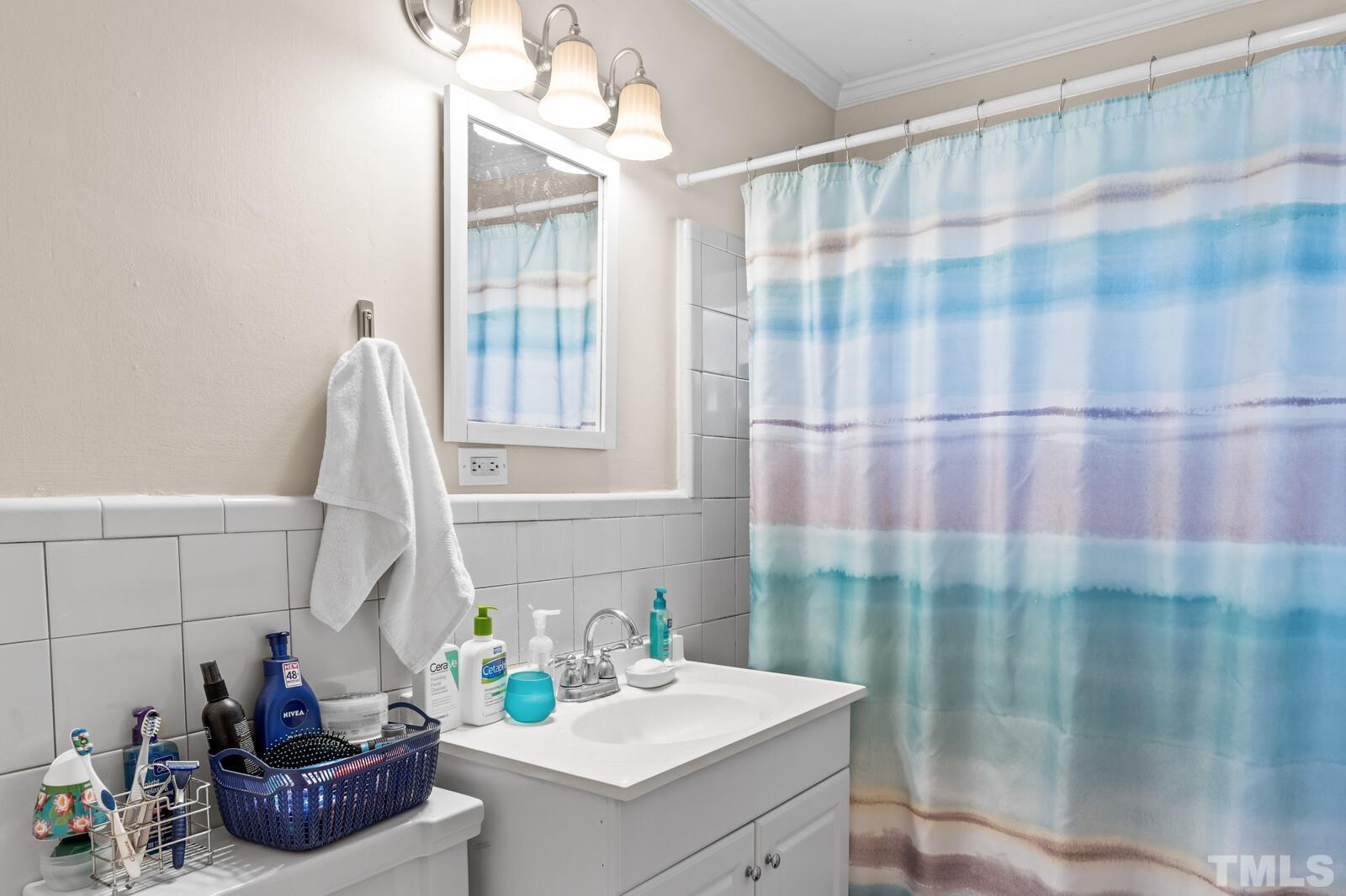 827 Athens Drive Raleigh, NC 27606 - Photo 14 of 34 a bathroom with a sink and a mirror