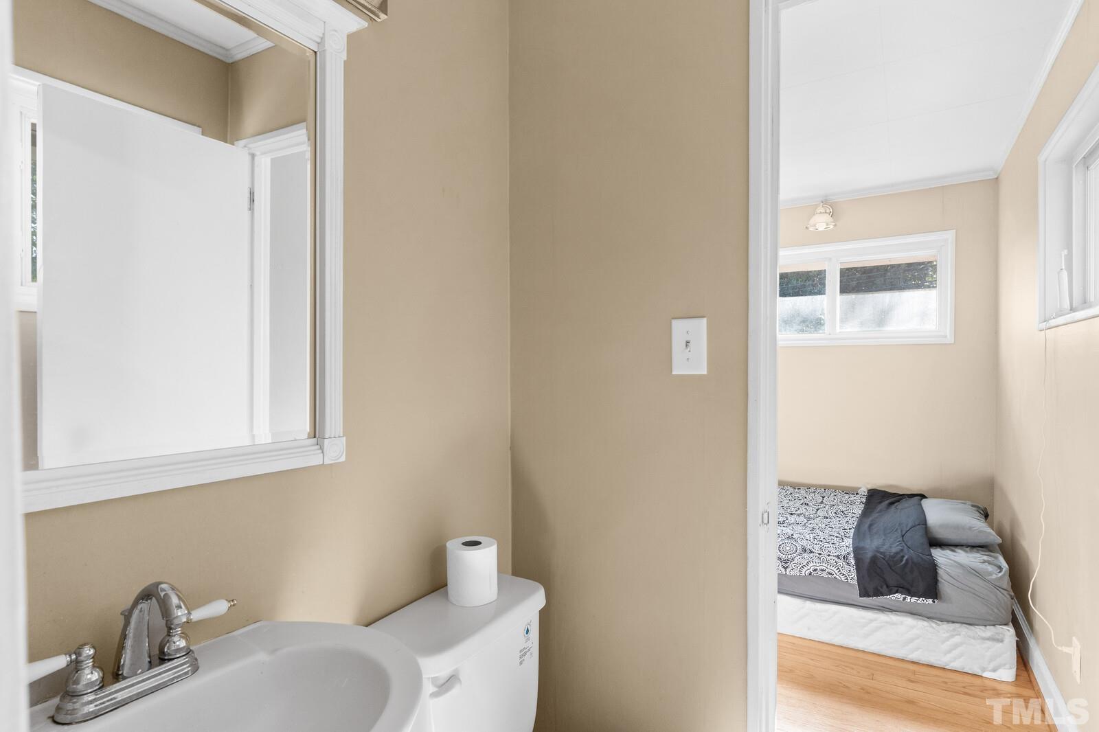 827 Athens Drive Raleigh, NC 27606 - Photo 16 of 34 a bathroom with a sink and a mirror