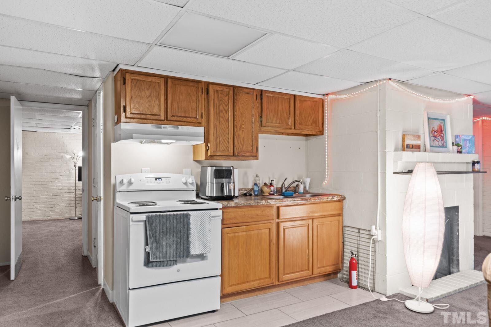 827 Athens Drive Raleigh, NC 27606 - Photo 19 of 34 a kitchen with a stove top oven sink and refrigerator