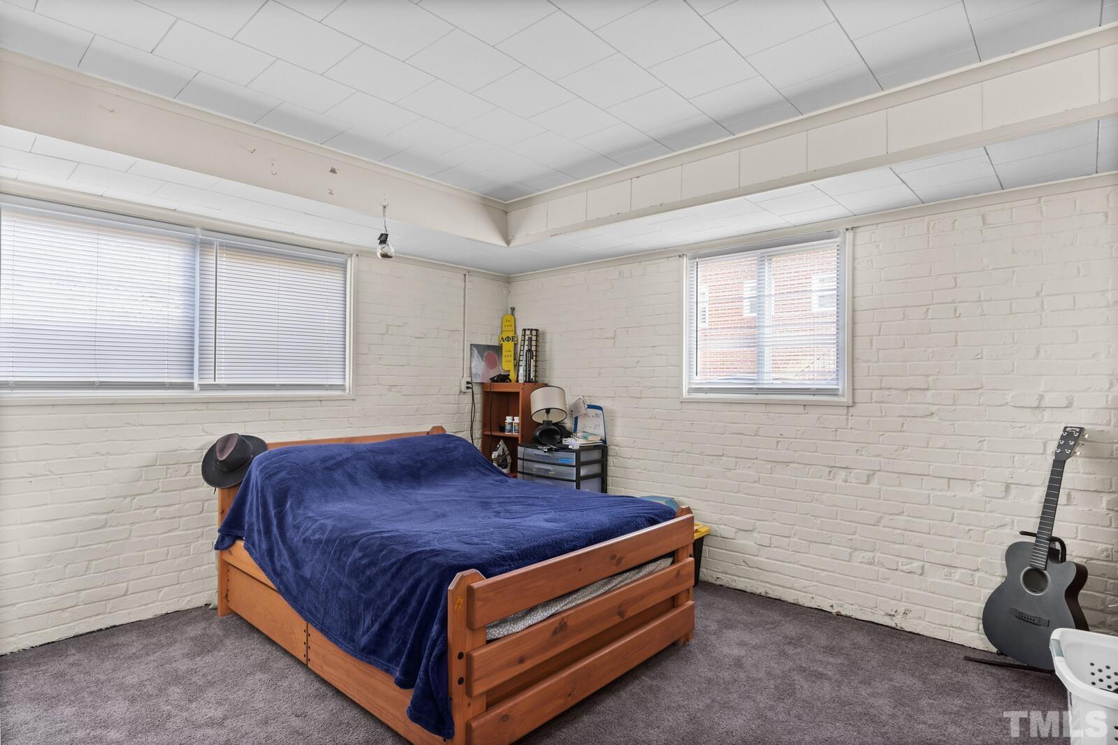 827 Athens Drive Raleigh, NC 27606 - Photo 20 of 34 a bed room with a bed and a window