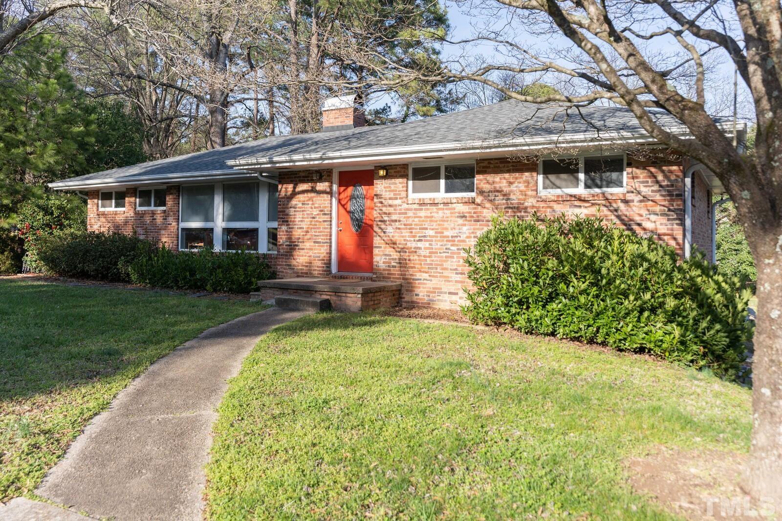 827 Athens Drive Raleigh, NC 27606 - Photo 2 of 34 a front view of a house with garden
