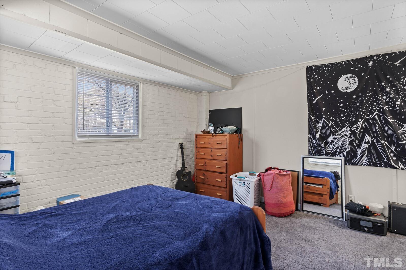 827 Athens Drive Raleigh, NC 27606 - Photo 21 of 34 a bedroom with bed and a window