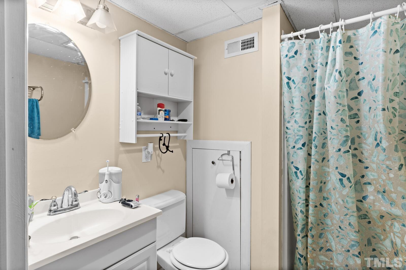 827 Athens Drive Raleigh, NC 27606 - Photo 24 of 34 a bathroom with a sink toilet and shower