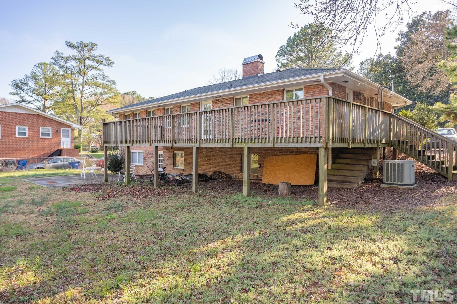 827 Athens Drive Raleigh, NC 27606 - Photo 28 of 34 a view of a house with a yard and sitting area
