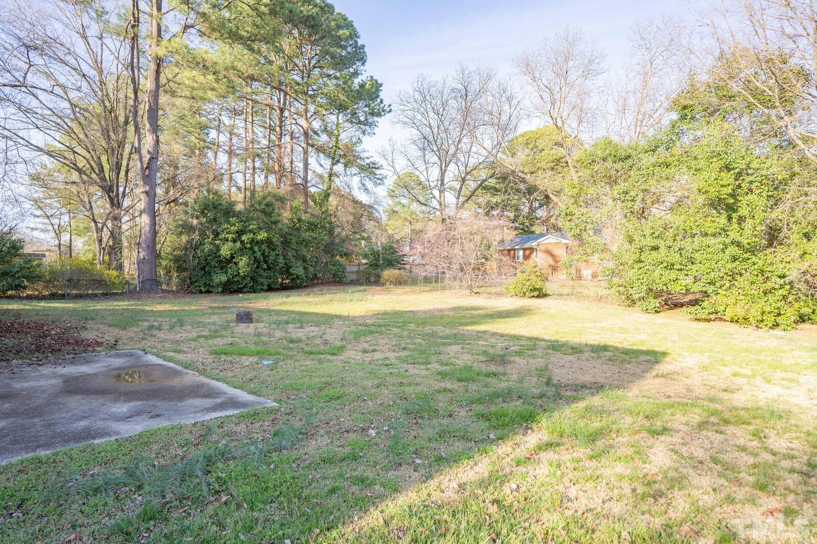 827 Athens Drive Raleigh, NC 27606 - Photo 31 of 34 a view of a yard with a house