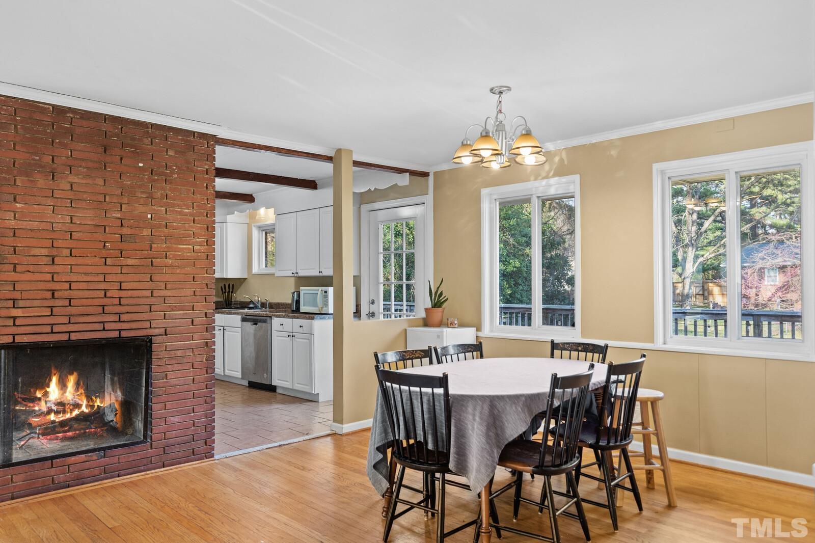 827 Athens Drive Raleigh, NC 27606 - Photo 6 of 34 a dining room with furniture window and wooden floor