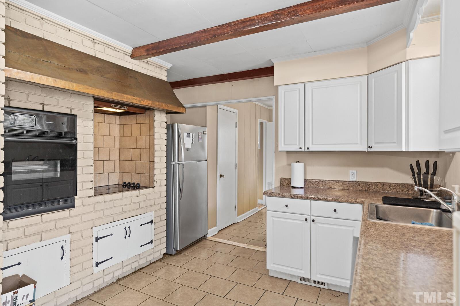 827 Athens Drive Raleigh, NC 27606 - Photo 7 of 34 a kitchen with white cabinets and sink