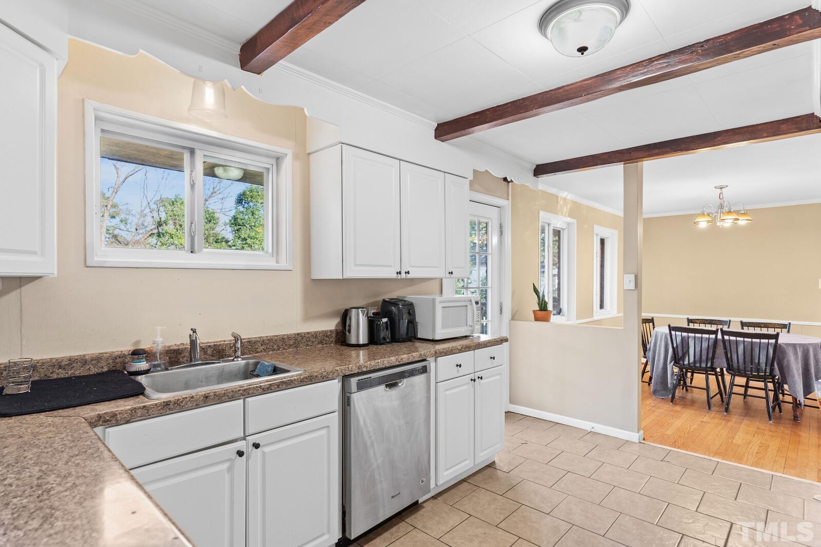 827 Athens Drive Raleigh, NC 27606 - Photo 9 of 34 a kitchen with a sink and cabinets