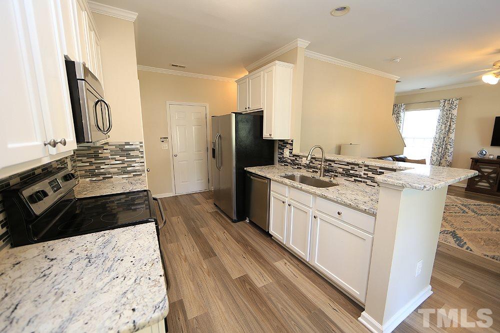 8423 Stone Mason Drive Raleigh, NC 27613 - Photo 3 of 11 Has Granite Counter tops, Tile Back Splash and Fresh White Cabinets