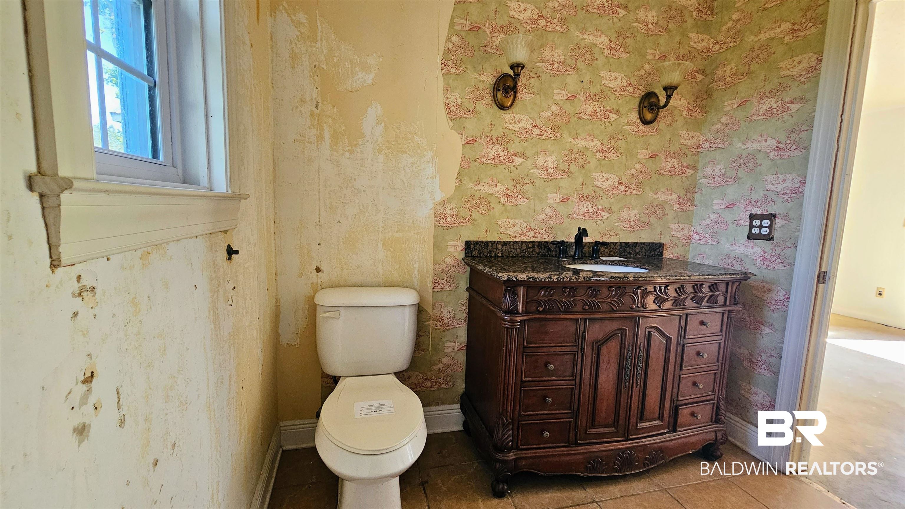 18824 Highway 41 Brewton, AL 36426 - Photo 25 of 40 Granite-topped vanity with carved wood details and a single basin