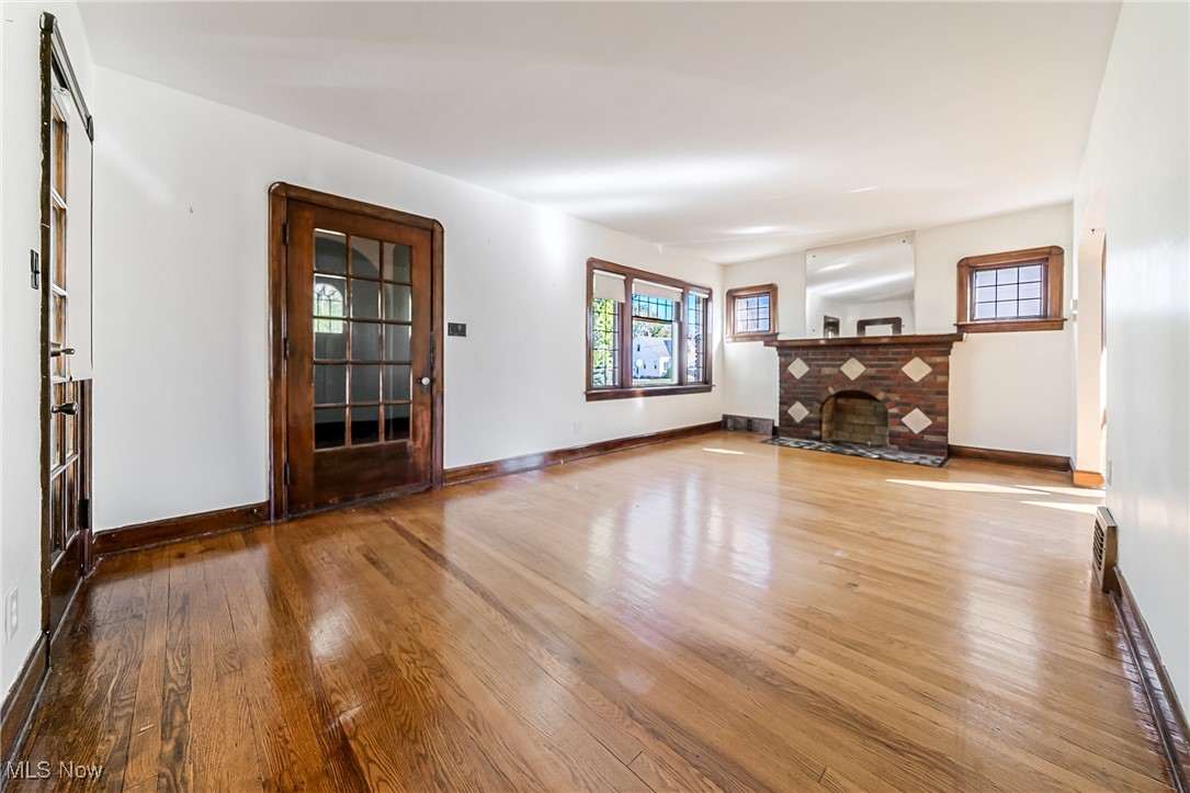 6711 Forest Avenue Parma, OH 44129 - Photo 5 of 33 Unfurnished living room with hardwood / wood-style flooring and a fireplace
