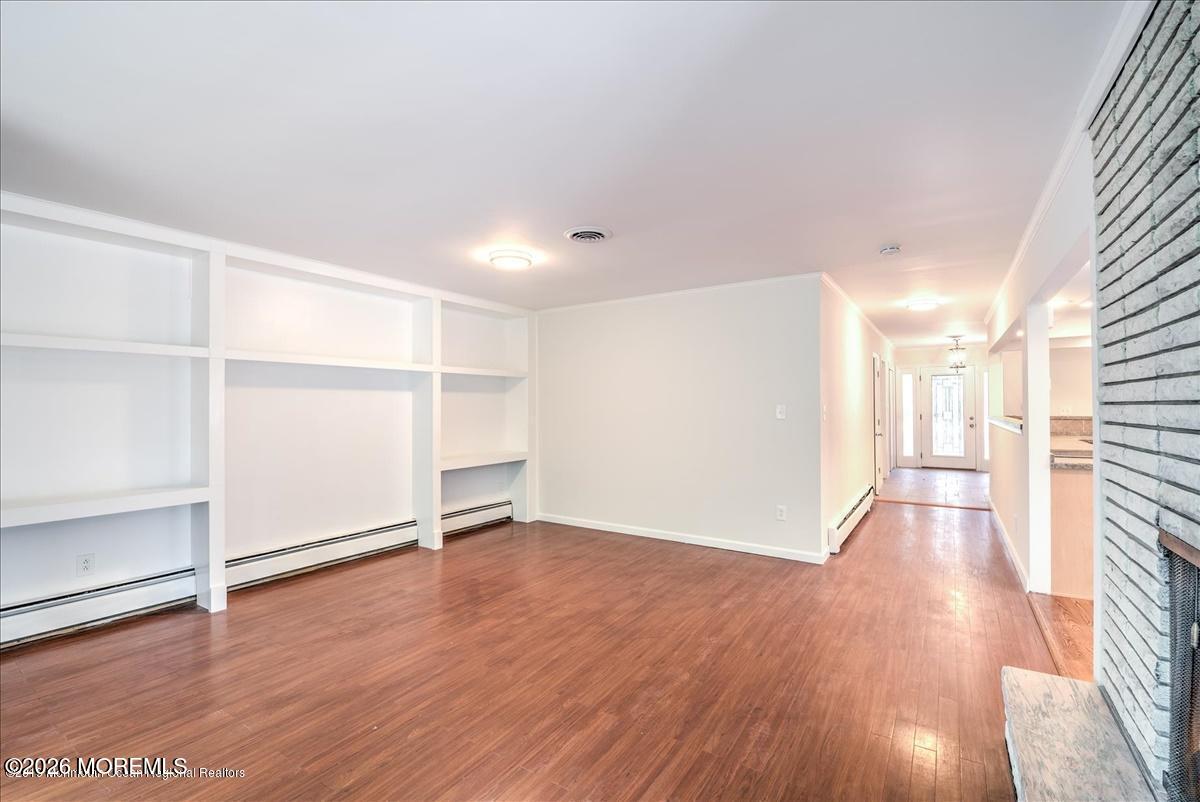 699 Aldrich Road Howell, NJ 07731 - Photo 10 of 23 a view of an empty room with wooden floor and a window