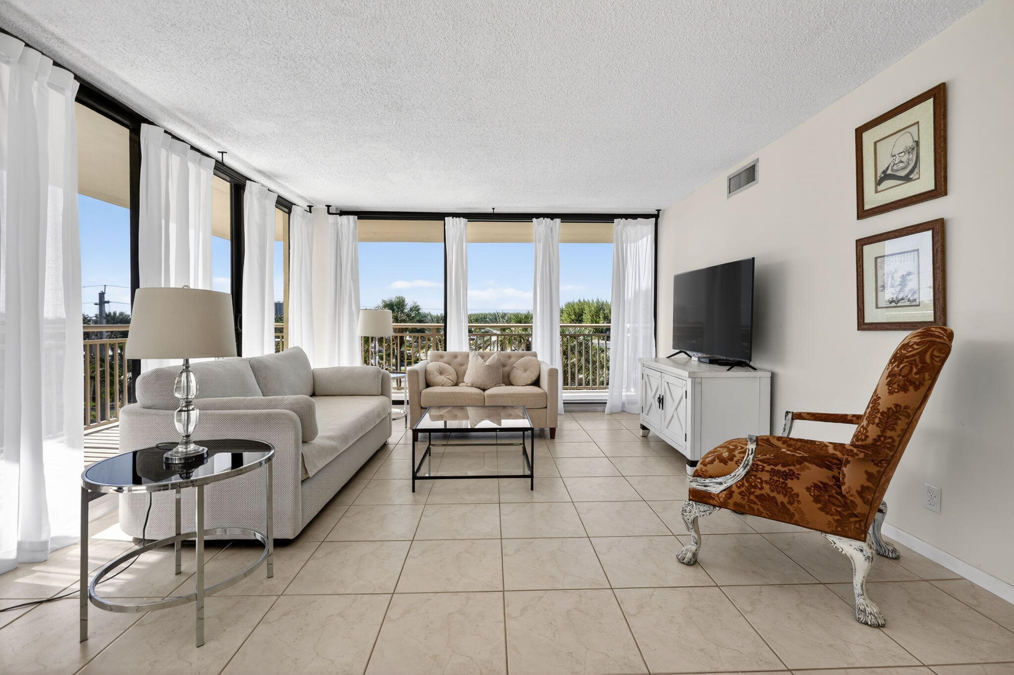 3400 North Ocean Drive, Unit 408 Singer Island, FL 33404 - Photo 3 of 31 a living room with furniture and a flat screen tv