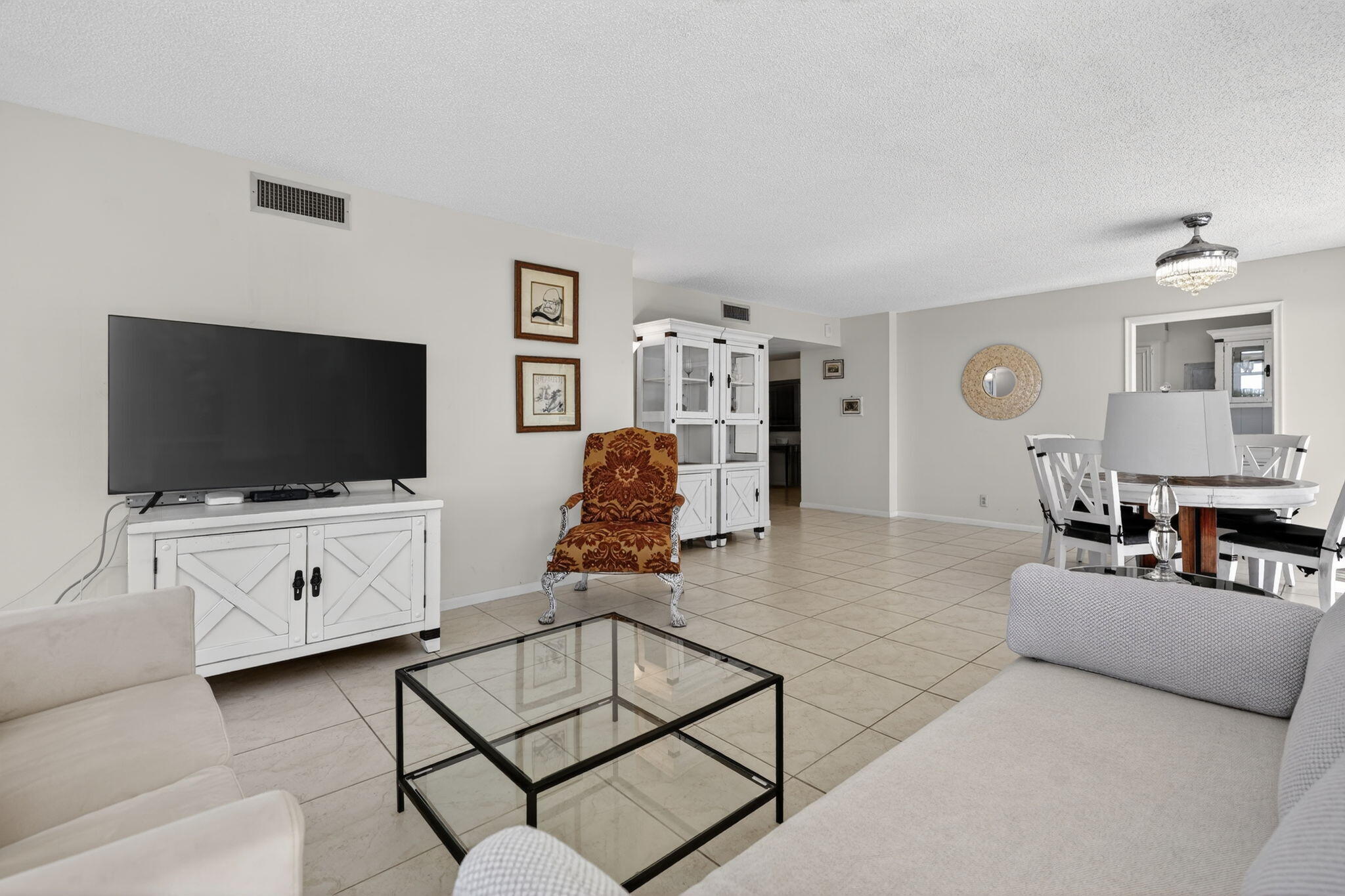 3400 North Ocean Drive, Unit 408 Singer Island, FL 33404 - Photo 4 of 31 a living room with furniture and a flat screen tv