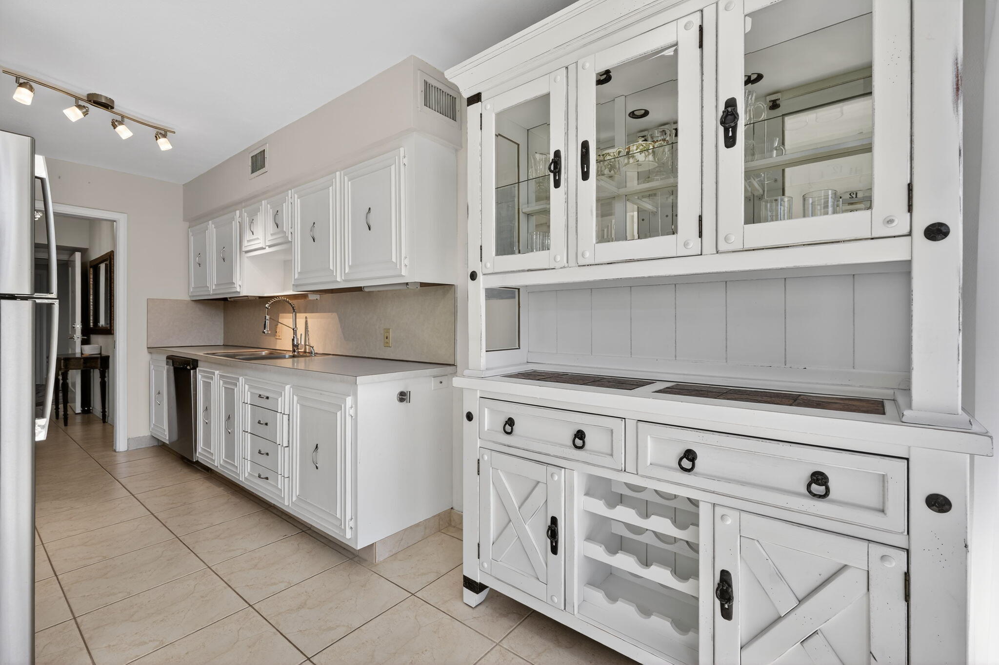 3400 North Ocean Drive, Unit 408 Singer Island, FL 33404 - Photo 6 of 31 a kitchen with granite countertop white cabinets and stainless steel appliances