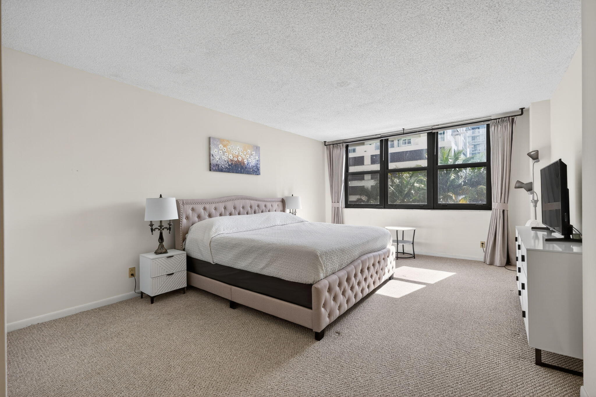 3400 North Ocean Drive, Unit 408 Singer Island, FL 33404 - Photo 7 of 31 a spacious bedroom with a bed and a large window