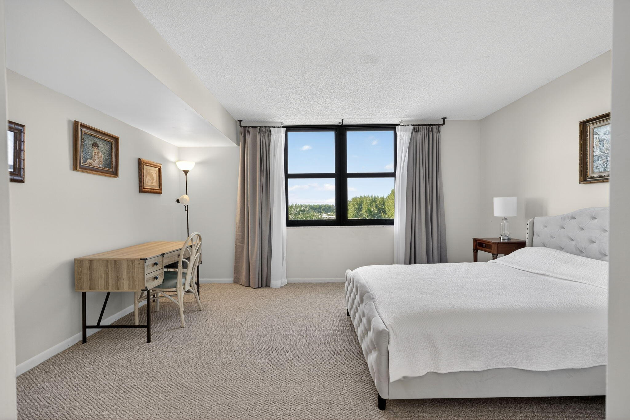 3400 North Ocean Drive, Unit 408 Singer Island, FL 33404 - Photo 10 of 31 a bedroom with a bed and a window