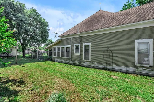 a view of a house with backyard porch and sitting area