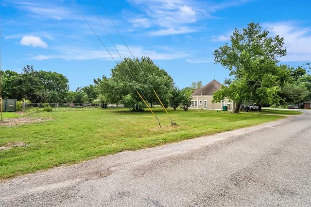 a view of a yard with a house in the background